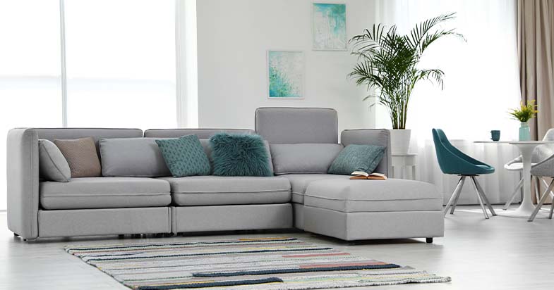 modern l-shaped recliner lounge sofa in a stylish living room with cushions