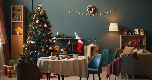 Warm and festive dining room with a decorated Christmas tree and gifts, featuring best furniture deals for the 2025 sale.