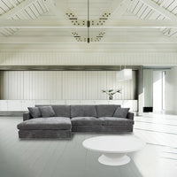 Licorice Brody Fab 2.5 Seater with LHF Chaise, featuring sleek arms and polyester fabric, in a stylish space.