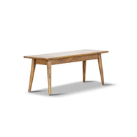 Mango wood bench with slim design and natural grain, displayed in a compact lounge area.