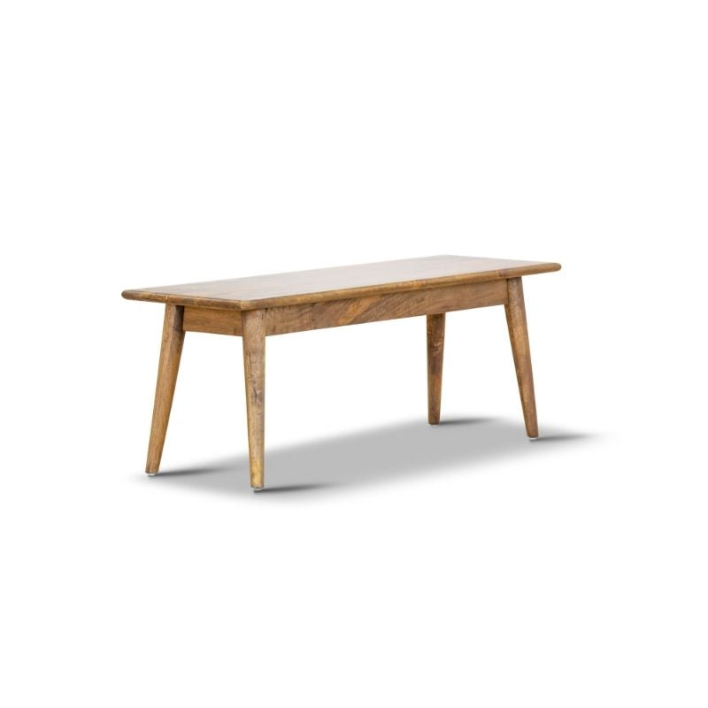 Mango wood bench with slim design and natural grain, displayed in a compact lounge area.
