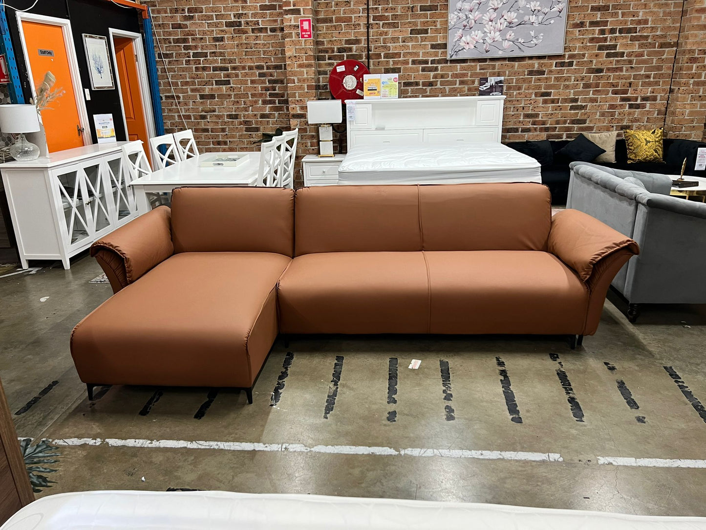 Beige Nile Reversal Sofabed with polyester fabric and versatile design, in a stylish lounge.