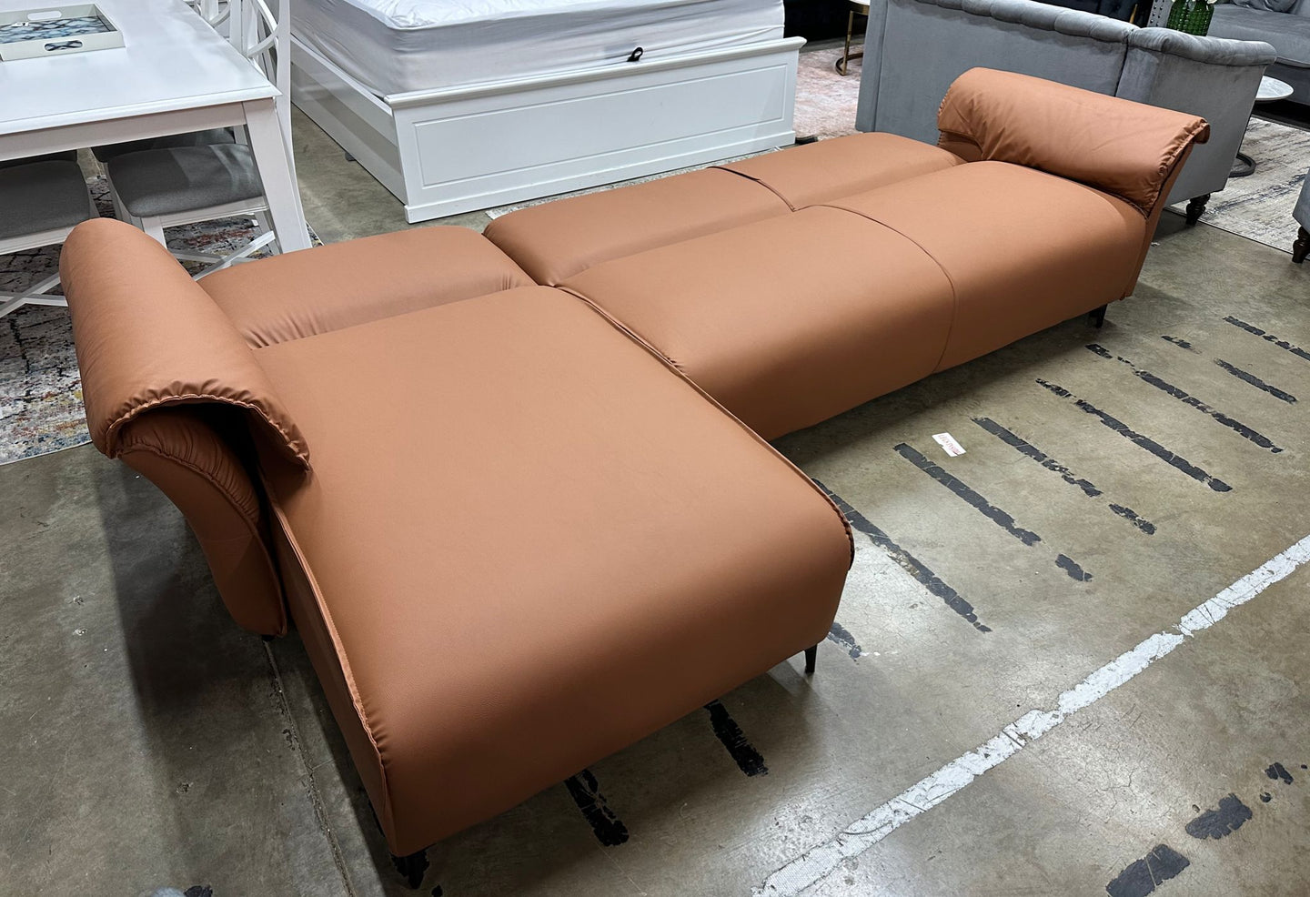 Tan air leather Nile Reversal Sofabed, perfect for small spaces, in a contemporary setting.