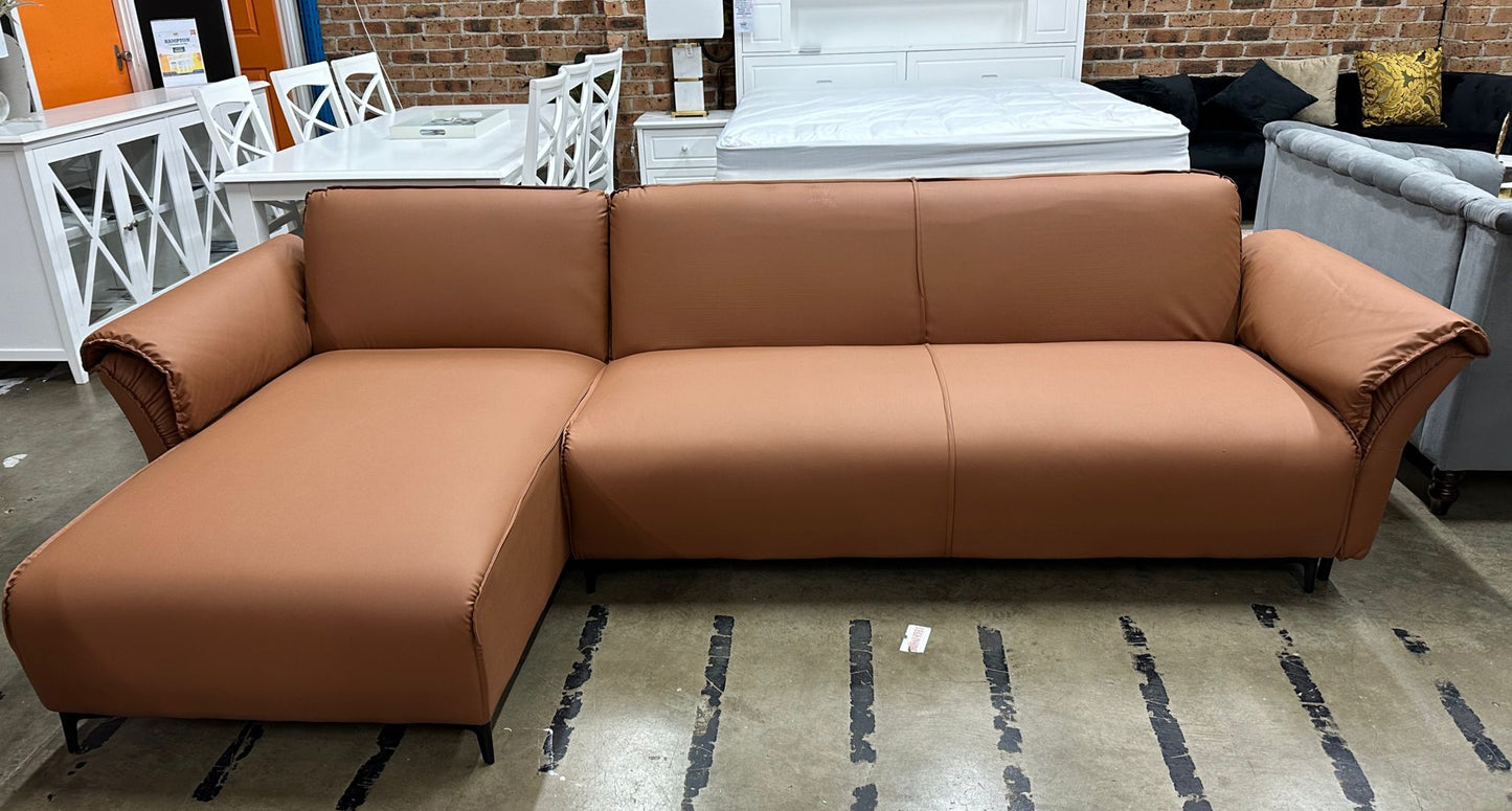 Tan air leather Nile Reversal Sofabed with reversible design, set in a modern living room.