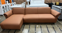 Tan air leather Nile Reversal Sofabed with reversible design, set in a modern living room.