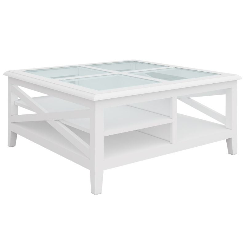 Acacia square coffee table with tempered glass top and silver handles, set in a coastal-inspired living room.