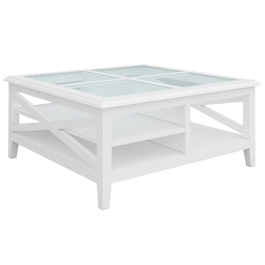 Acacia square coffee table with tempered glass top and silver handles, set in a coastal-inspired living room.