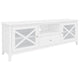 White acacia TV unit with tempered glass doors and silver handles, set in a coastal living room.