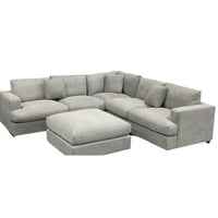 Dark Grey Hasting Lounge with Ottoman, goose feather cushions, and three scatter cushions, in a modern living room.