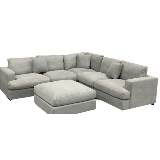 Dark Grey Hasting Lounge with Ottoman, goose feather cushions, and three scatter cushions, in a modern living room.