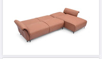 Tan Nile Reversal Sofabed in air leather, ideal for seating and sleeping, in a chic room.