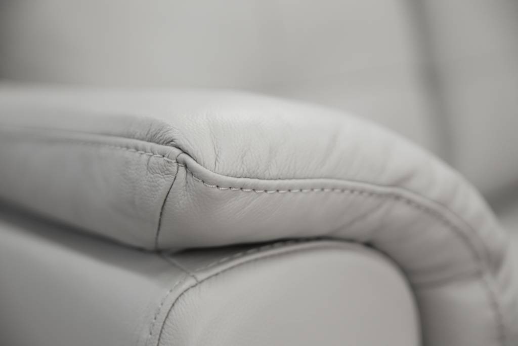 Modern 2 seater lounge with side pillow arms, channelled seat cushions, and premium leather upholstery, available in Silver or Gunmetal.