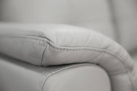 Modern 2 seater lounge with side pillow arms, channelled seat cushions, and premium leather upholstery, available in Silver or Gunmetal.