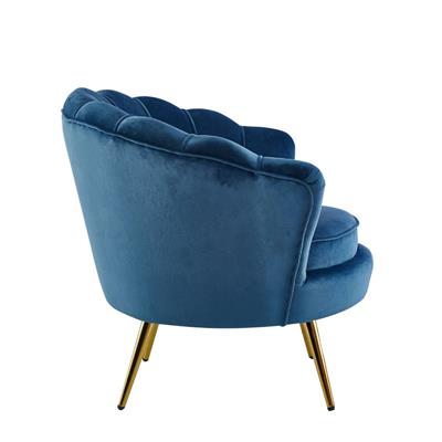 Serena Armchair with soft velvet and round seat, displayed in a glamorous reading corner.
