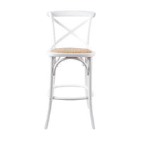 Steam-bent bar stool with woven rattan pad, displayed in a stylish kitchen area.
