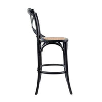 Rattan-padded bar stool with sturdy birch construction, set in a modern dining area.