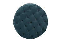 Velvet-upholstered ottoman with solid wood frame and pocket springs, displayed in a cozy lounge.