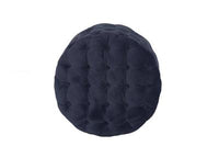 Tufted velvet ottoman with sturdy plywood frame, set in a modern living area.