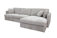 Slate Brody Fab 2.5 Seater with RHF Chaise, featuring foam cushions and a sturdy frame, in a bright space.