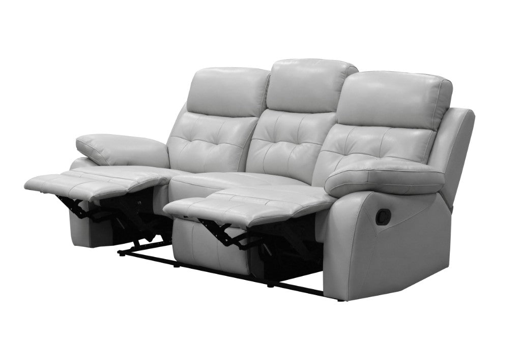 Silver Cosmic 3S Lounge with corrected grain leather and lumbar support, in a cozy space.