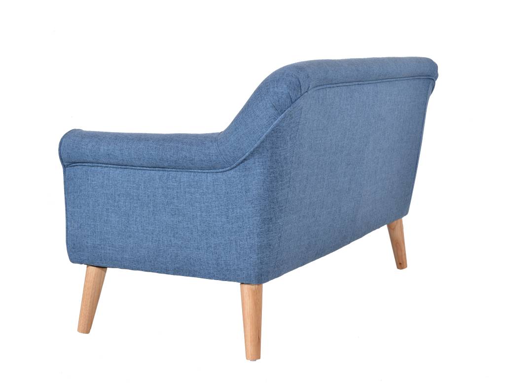 Green Lavender 2.5 Seater with slanted arms and classic design, set on oak legs in a cozy corner.