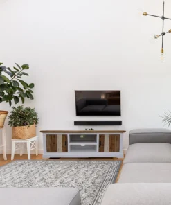 Vibrant acacia sideboard with unique design and metal handles, set in a colorful living room.